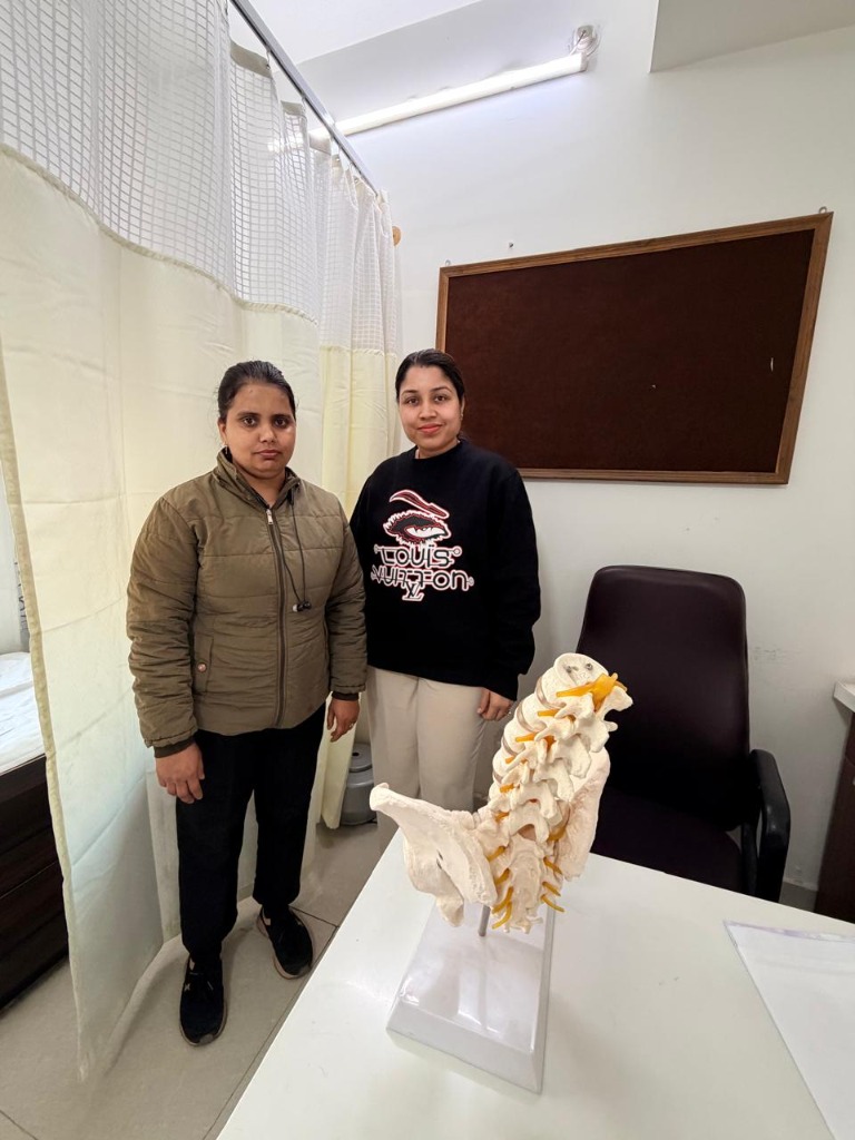 Dr. Nikita consulting patient with spine model